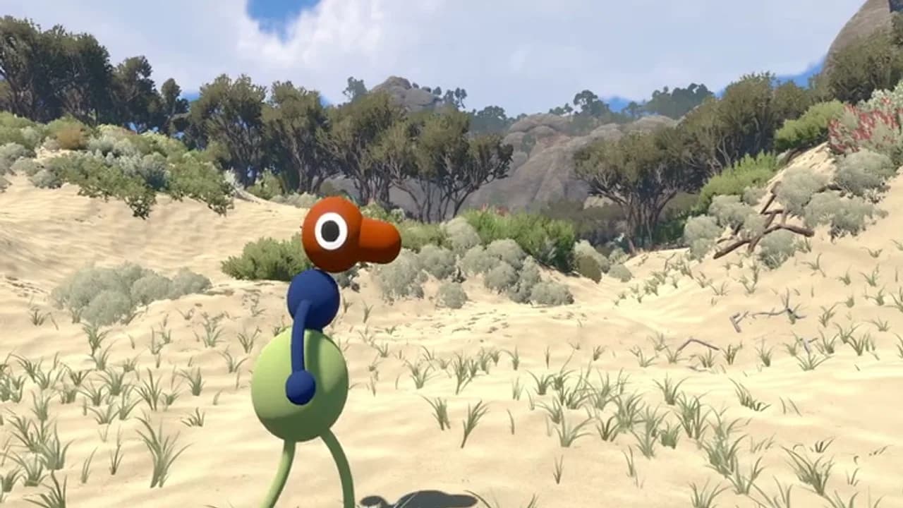 A Big Walk character crossing a sandy, shrub-covered landscape